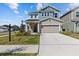 Charming two-story home featuring a well-manicured lawn and a spacious two-car garage at 28889 Orange Berry # Dr, Wesley Chapel, FL 33543