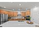 Spacious gourmet kitchen featuring stainless steel appliances, a large island, and stylish wood cabinetry at 28889 Orange Berry # Dr, Wesley Chapel, FL 33543