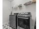 Functional laundry room featuring modern appliances and stylish star-patterned tile flooring at 28889 Orange Berry # Dr, Wesley Chapel, FL 33543