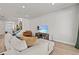 Relaxing living room area with plush sectional couch and view of the stairway and the front door at 28889 Orange Berry # Dr, Wesley Chapel, FL 33543