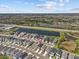 Aerial view of homes next to a pond and wooded area in a planned community at 28889 Orange Berry # Dr, Wesley Chapel, FL 33543