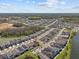 Aerial view of homes next to a pond and wooded area in a planned community at 28889 Orange Berry # Dr, Wesley Chapel, FL 33543