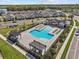 Aerial view of community pool with lounge chairs and shaded pergola in planned community at 28889 Orange Berry # Dr, Wesley Chapel, FL 33543