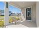 Cozy covered front porch with seating, perfect for relaxing outdoors at 28889 Orange Berry # Dr, Wesley Chapel, FL 33543