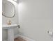 Elegant powder room featuring a pedestal sink with gold faucet and a decorative gold mirror at 28889 Orange Berry # Dr, Wesley Chapel, FL 33543