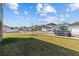 Street view of home featuring landscaped front yard and tree lined streets in a sidewalk community at 28889 Orange Berry # Dr, Wesley Chapel, FL 33543
