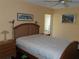 Comfortable bedroom with a wood-framed bed, bedside tables, and artwork on the walls at 2960 59Th S St # 501, Gulfport, FL 33707
