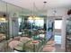 Dining area with a glass table, seating eight and mirrored wall for a spacious feel at 2960 59Th S St # 501, Gulfport, FL 33707
