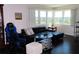 Cozy living room with black leather couch, a view of the water, and natural light at 2960 59Th S St # 501, Gulfport, FL 33707