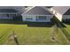 Aerial view of the backyard featuring a manicured lawn and black metal fence at 33410 Castaway Loop, Wesley Chapel, FL 33543