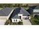 Aerial shot of a single-story home with a well-manicured lawn and a spacious driveway at 33410 Castaway Loop, Wesley Chapel, FL 33543
