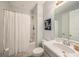 This bathroom features a shower with tub, white vanity, mirror and tile flooring at 33410 Castaway Loop, Wesley Chapel, FL 33543