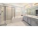 Luxurious bathroom featuring a soaking tub, walk-in shower, and double vanity at 33410 Castaway Loop, Wesley Chapel, FL 33543