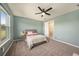 Cozy bedroom with large windows, ceiling fan and neutral colored carpet at 33410 Castaway Loop, Wesley Chapel, FL 33543