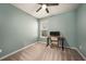 This bedroom features blue walls, carpeted floors, a ceiling fan and a window for natural light at 33410 Castaway Loop, Wesley Chapel, FL 33543