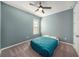 This bedroom features blue walls, a ceiling fan, carpeted floors and a window for natural light at 33410 Castaway Loop, Wesley Chapel, FL 33543