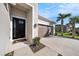 Single-story house featuring a brown garage door and a welcoming front entrance at 33410 Castaway Loop, Wesley Chapel, FL 33543