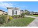 Well-manicured lawn in front of a single-story home with black window shutters at 33410 Castaway Loop, Wesley Chapel, FL 33543