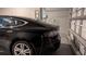 Garage interior featuring a black car charging from an installed wall charger at 33410 Castaway Loop, Wesley Chapel, FL 33543