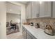 Galley-style kitchen with office nook and stainless steel appliances at 33410 Castaway Loop, Wesley Chapel, FL 33543