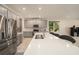 Modern kitchen with stainless steel appliances, large island and gray cabinetry at 33410 Castaway Loop, Wesley Chapel, FL 33543