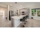 Spacious kitchen with white cabinets, quartz counters, and stainless steel appliances at 33410 Castaway Loop, Wesley Chapel, FL 33543