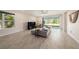 Bright living room with wood floors, neutral tones and sliding doors to outside space at 33410 Castaway Loop, Wesley Chapel, FL 33543