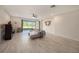 Spacious living room featuring tile floors, neutral paint, and sliding glass doors at 33410 Castaway Loop, Wesley Chapel, FL 33543