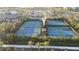 Aerial view of tennis and pickleball courts surrounded by lush landscaping and palm trees at 33410 Castaway Loop, Wesley Chapel, FL 33543