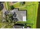 A clean aerial view shows the house, yard, roof, and partial view of a beautiful pond at 3629 Mossy Oak Cir, Land O Lakes, FL 34639