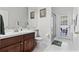 Modern bathroom boasts a vanity with dark wood cabinets, tiled floors, and a glass-enclosed shower at 3629 Mossy Oak Cir, Land O Lakes, FL 34639