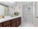 Clean bathroom features a vanity with storage, large mirror, and natural light at 3629 Mossy Oak Cir, Land O Lakes, FL 34639