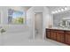 Bright bathroom showcasing a soaking tub, vanity with storage, and plenty of natural light at 3629 Mossy Oak Cir, Land O Lakes, FL 34639