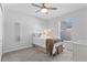 Cozy bedroom with neutral colors, ceiling fan, and a window with natural light at 3629 Mossy Oak Cir, Land O Lakes, FL 34639