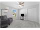 Bright bedroom featuring neutral walls, plush carpeting, and a modern ceiling fan with a light fixture at 3629 Mossy Oak Cir, Land O Lakes, FL 34639