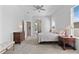 Comfortable bedroom with natural light, ceiling fan, and doorway to outdoors at 3629 Mossy Oak Cir, Land O Lakes, FL 34639
