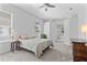 Relaxing bedroom with neutral tones, ceiling fan, and access to en-suite bathroom at 3629 Mossy Oak Cir, Land O Lakes, FL 34639