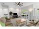 Bright living room featuring large windows, ceiling fan, and neutral tones at 3629 Mossy Oak Cir, Land O Lakes, FL 34639
