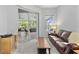 Inviting living room with carpeted floor, couch, and access to screened patio at 3629 Mossy Oak Cir, Land O Lakes, FL 34639