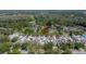 Aerial view of the home nestled in a lush, green, wooded community at 370 S Woodlands Dr, Oldsmar, FL 34677