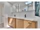 The bathroom has a double sink, modern fixtures, and a glass-enclosed shower with pebble flooring at 370 S Woodlands Dr, Oldsmar, FL 34677