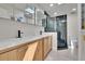 Modern bathroom featuring a double vanity, sleek mirrors, and an elegant walk-in shower at 370 S Woodlands Dr, Oldsmar, FL 34677