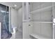 Bright bathroom featuring modern fixtures, a shower with dark marble-style tile, and ample storage space at 370 S Woodlands Dr, Oldsmar, FL 34677