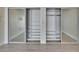 Bedroom featuring large closets with mirrored doors for ample storage space at 370 S Woodlands Dr, Oldsmar, FL 34677