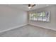 A bright bedroom featuring plantation shutters, a ceiling fan, and wood-look tile flooring at 370 S Woodlands Dr, Oldsmar, FL 34677