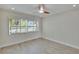 Bright bedroom features shuttered windows, wood-look floors, and lots of natural light at 370 S Woodlands Dr, Oldsmar, FL 34677