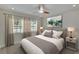 Serene bedroom with neutral tones, plush bedding, and large windows offering ample natural light at 370 S Woodlands Dr, Oldsmar, FL 34677