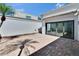 Private courtyard with brick pavers, mature landscaping, and modern glass sliders at 370 S Woodlands Dr, Oldsmar, FL 34677