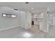 Open dining area with light wood floors that lead to the kitchen with white cabinets at 370 S Woodlands Dr, Oldsmar, FL 34677