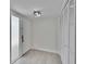 Inviting entryway features a front door, light, closet, and light wood floors at 370 S Woodlands Dr, Oldsmar, FL 34677